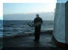 Me holding the wreathes before laying them into the sea.